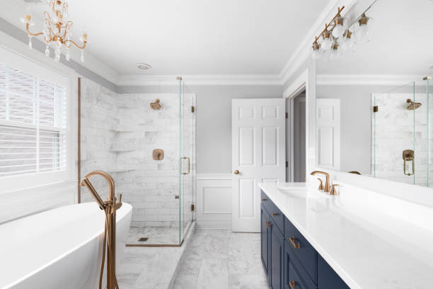 Bathroom with white walls and navy blue cabinetry by an interior painter in Chadds Ford, PA.