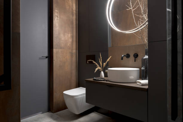 Bathroom with charcoal walls, black cabinetry and warm brown wood accents by an interior painter in Chadds Ford, PA.